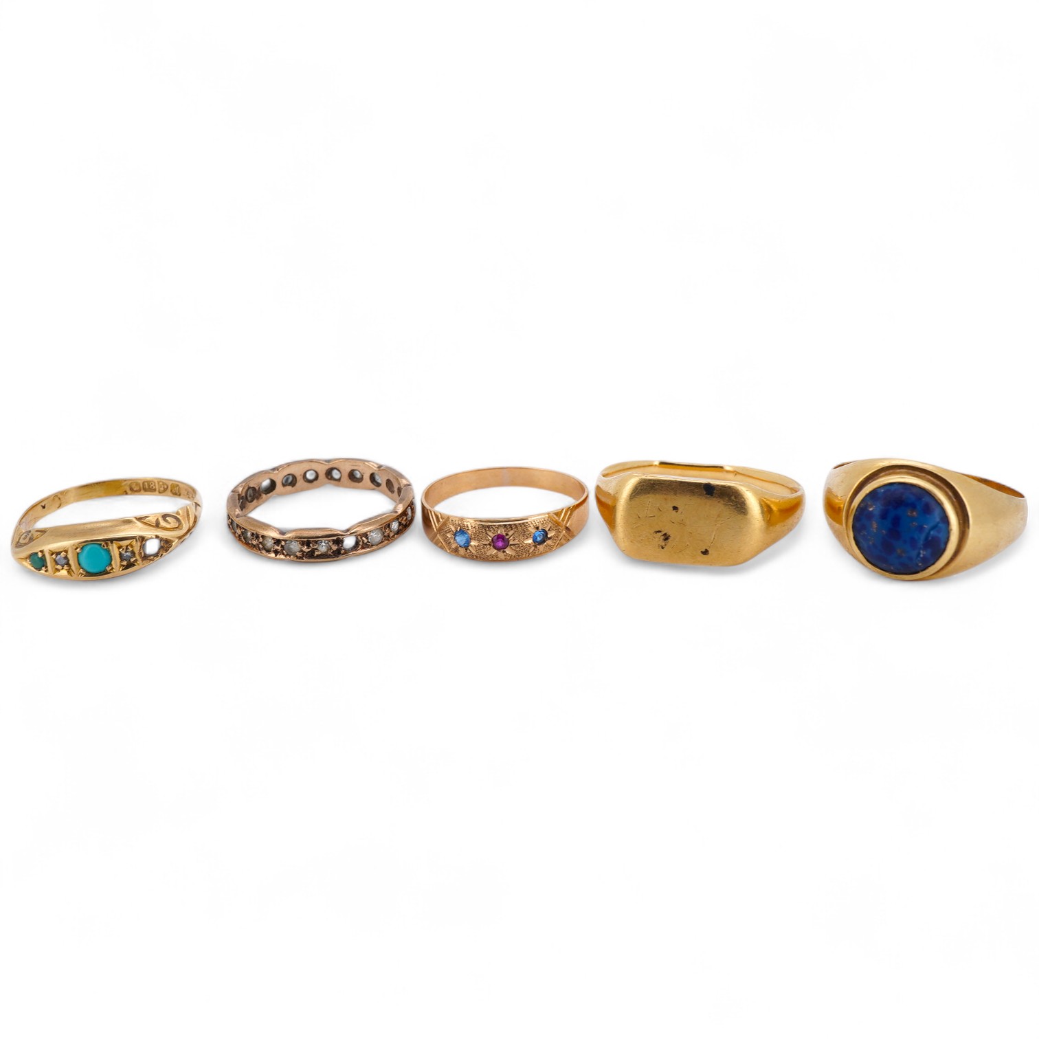 Five gold rings, comprising: an 18ct gold and turquoise ring, British hallmarks; a paste eternity ring; a synthetic sapphire and synthetic ruby ring; and a signet ring, faintly engraved, combined gross weight approximate